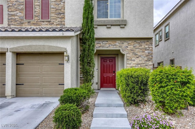 view of exterior entry featuring a garage, stucco siding, and stone siding