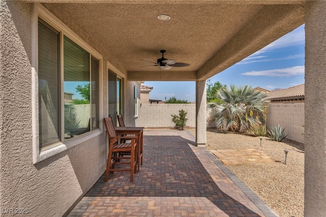 view of patio / terrace with a fenced backyard and ceiling fan