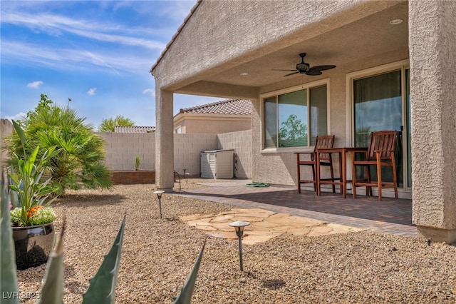 view of patio with fence and ceiling fan