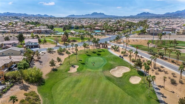 aerial view featuring view of golf course, a mountain view, and a residential view