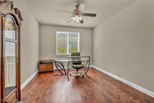 office space with dark wood finished floors, a ceiling fan, and baseboards