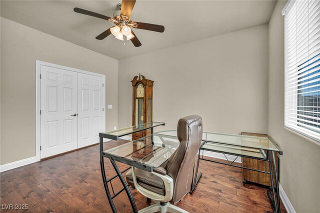 office area with a ceiling fan, baseboards, and dark wood-style flooring