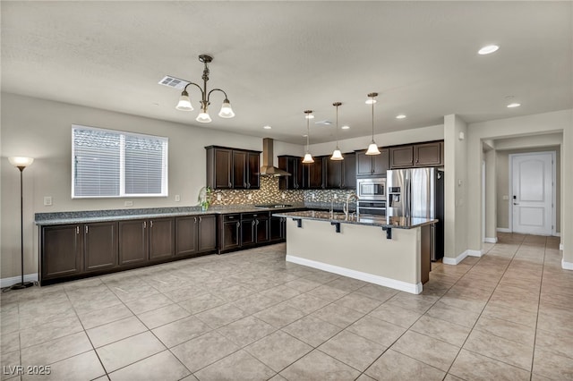 kitchen featuring dark brown cabinets, visible vents, dark stone counters, tasteful backsplash, and appliances with stainless steel finishes
