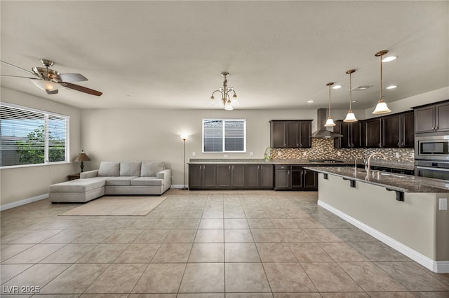 living area with a ceiling fan, baseboards, recessed lighting, and light tile patterned floors