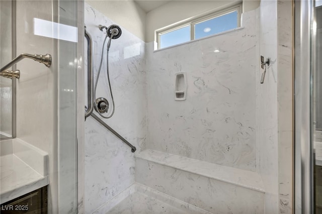 full bathroom with vanity and a marble finish shower