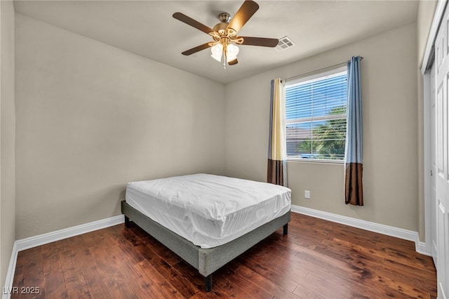 bedroom with visible vents, baseboards, and wood-type flooring