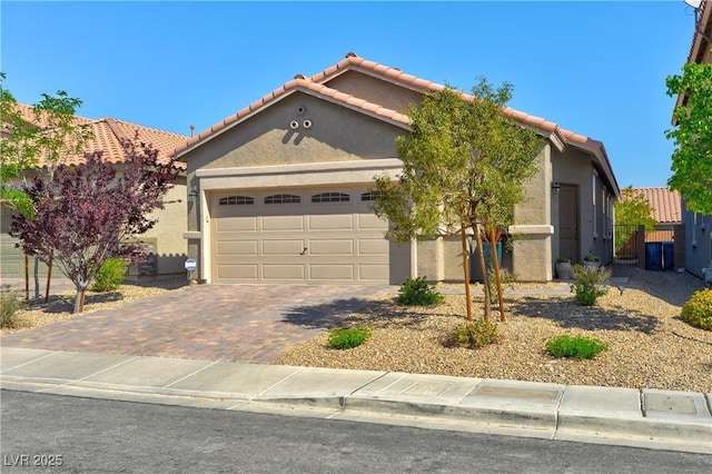 8036 Literature Ct, Las Vegas, NV 89113 - view of front of home featuring fence, a tiled roof, stucco siding, driveway, and a garage