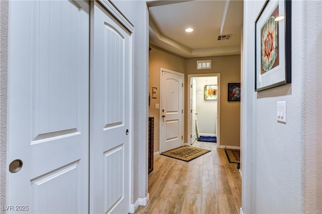 8036 Literature Ct, Las Vegas, NV 89113 - entryway with a tray ceiling, light wood-type flooring, baseboards, visible vents, and recessed lighting