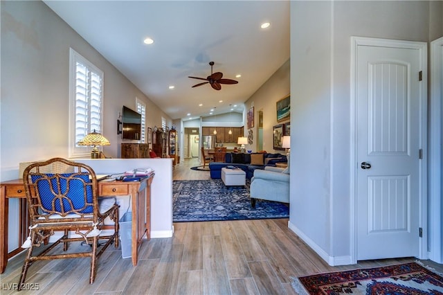 8036 Literature Ct, Las Vegas, NV 89113 - living room featuring vaulted ceiling, baseboards, recessed lighting, a ceiling fan, and wood finished floors