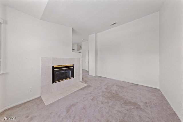 8128 Bay Pines Ave, Las Vegas, NV 89128 - unfurnished living room featuring carpet, visible vents, a tile fireplace, and baseboards