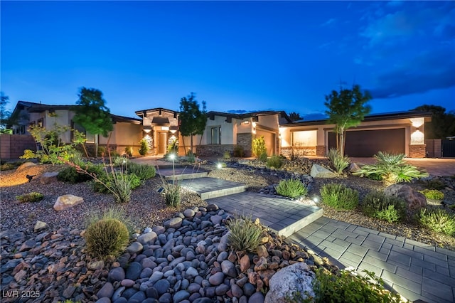 mediterranean / spanish-style house with an attached garage and stucco siding