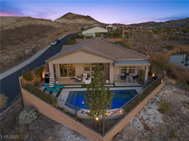 rear view of property featuring a fenced backyard, stucco siding, and a mountain view