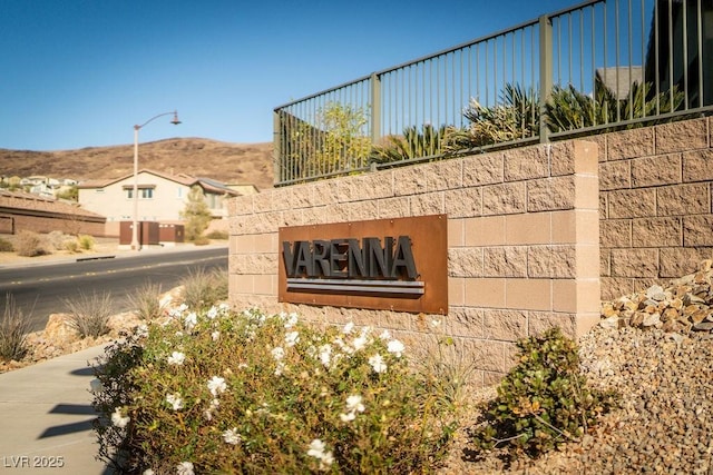 community sign with a mountain view