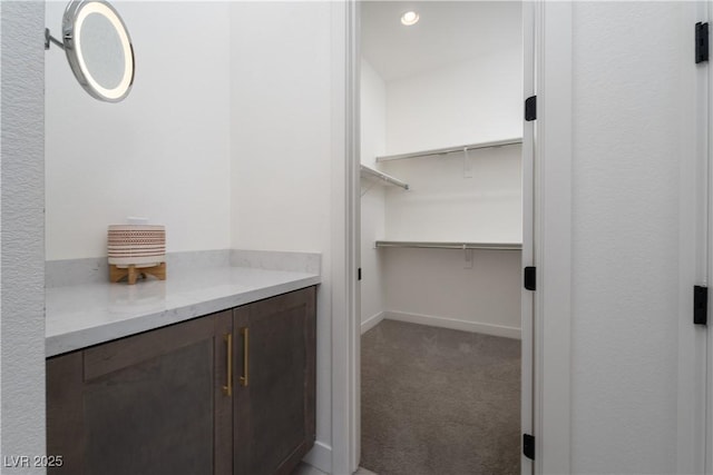 walk in closet featuring carpet