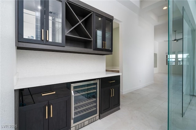 91 Alta Cascata Pl, Henderson, NV 89011 - bar featuring baseboards, wine cooler, and a bar