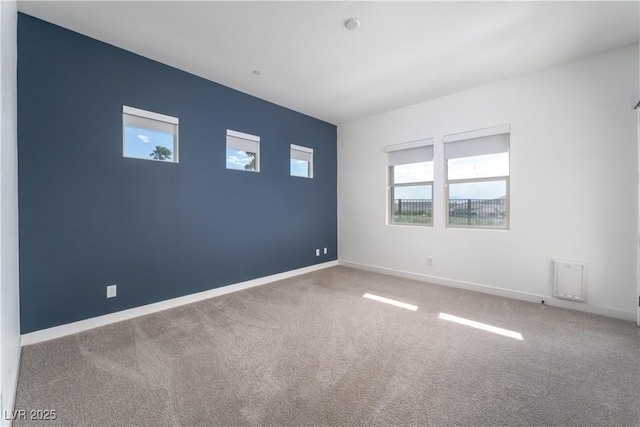 empty room with carpet floors and baseboards