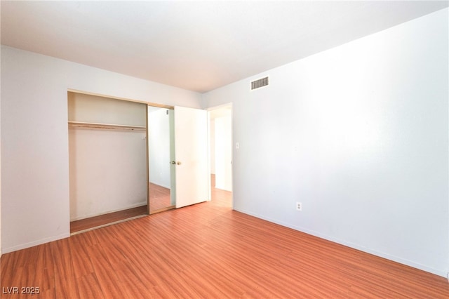 4687 Monterey Cir Unit 1, Las Vegas, NV 89169 - unfurnished bedroom featuring light wood-type flooring, baseboards, visible vents, and a closet
