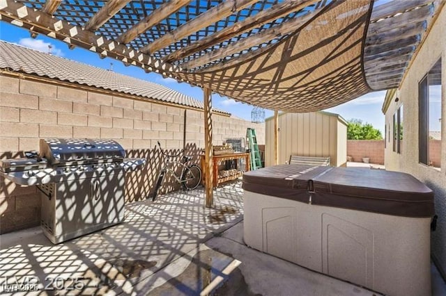view of patio featuring a fenced backyard, grilling area, an outdoor structure, a storage unit, and a hot tub