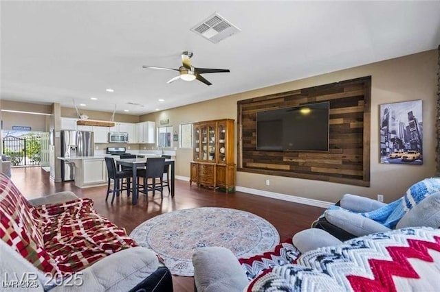 living room with ceiling fan, baseboards, dark wood-type flooring, visible vents, and recessed lighting