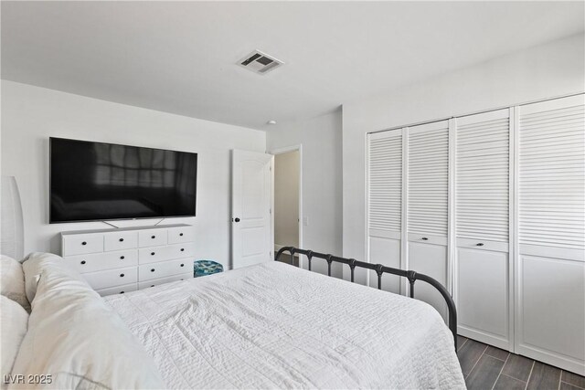 4298 Cartegena Way, Las Vegas, NV 89121 - bedroom with dark wood-style floors, visible vents, and a closet