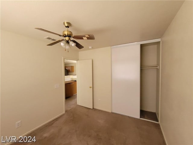 unfurnished bedroom featuring a ceiling fan, a closet, baseboards, carpet flooring, and visible vents