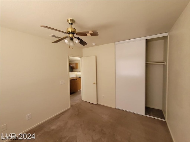 unfurnished bedroom with baseboards, visible vents, a ceiling fan, a closet, and carpet floors