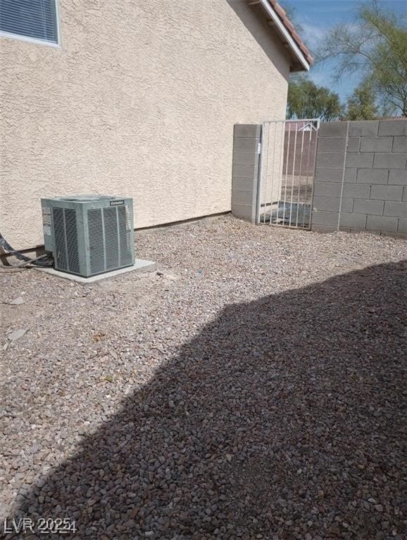 view of yard with fence and central air condition unit