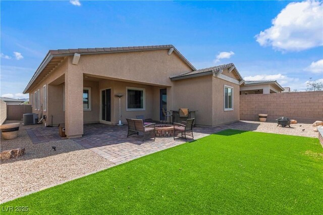 713 Webber Park St, Henderson, NV 89011 - rear view of house with a fenced backyard, central air condition unit, stucco siding, a lawn, and an outdoor fire pit