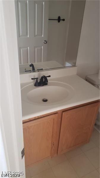 bathroom featuring tile patterned flooring and vanity