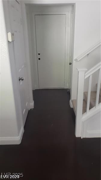 corridor featuring stairs and baseboards