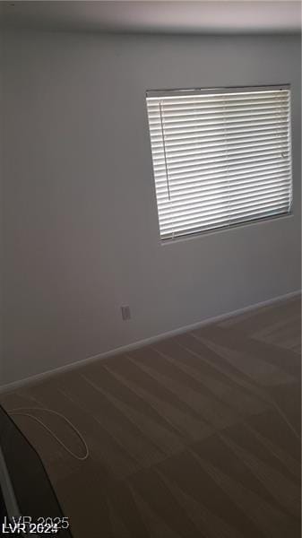 spare room featuring baseboards and a healthy amount of sunlight