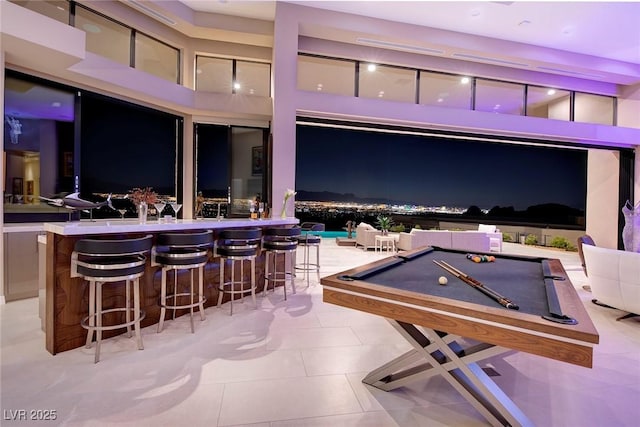 661 Dragon Peak Dr, Henderson, NV 89012 - game room featuring tile patterned flooring, a community bar, billiards, and a towering ceiling