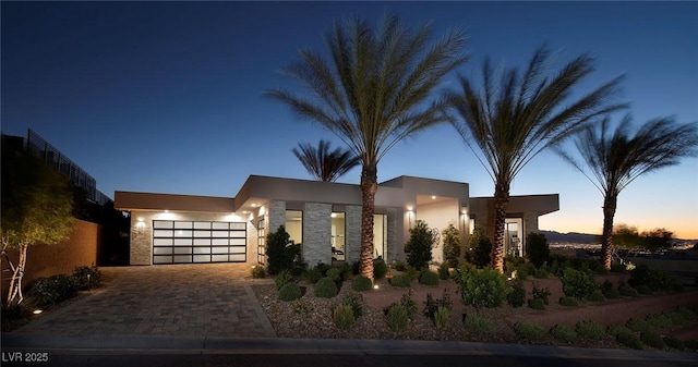 661 Dragon Peak Dr, Henderson, NV 89012 - view of front of property featuring an attached garage, stucco siding, and decorative driveway
