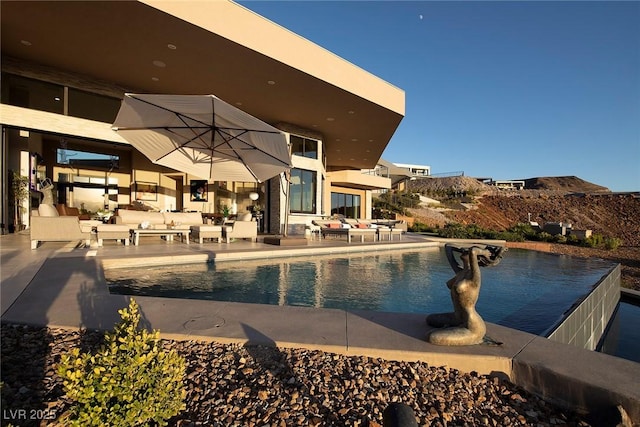 661 Dragon Peak Dr, Henderson, NV 89012 - outdoor pool featuring a patio area and an outdoor living space