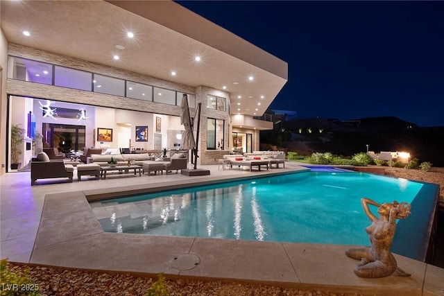 661 Dragon Peak Dr, Henderson, NV 89012 - pool at twilight featuring a patio area, an outdoor living space, and an outdoor pool