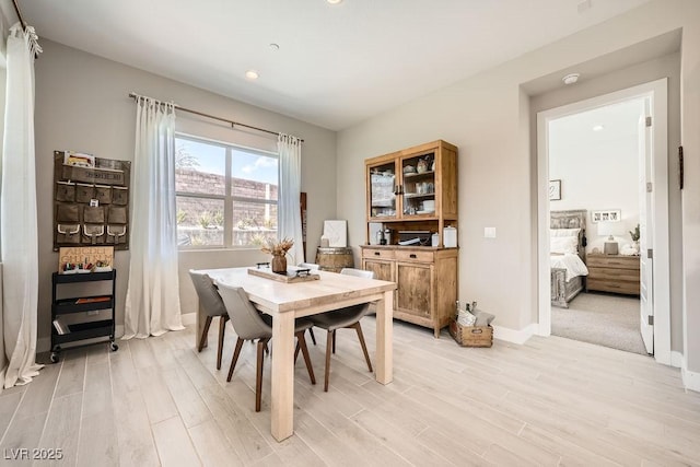 dining space with recessed lighting, baseboards, and light wood-type flooring