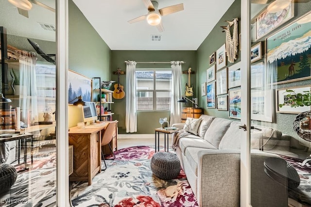 living area with ceiling fan and visible vents