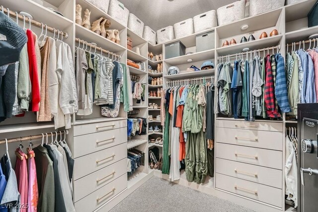walk in closet with carpet flooring