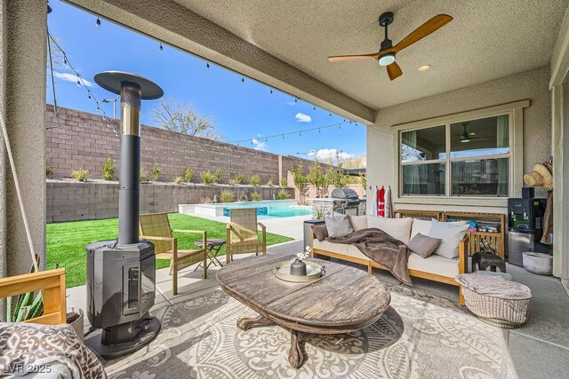 view of patio / terrace with ceiling fan, a fenced in pool, a fenced backyard, and an outdoor hangout area