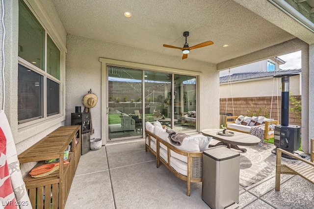 view of patio / terrace with fence, ceiling fan, and outdoor lounge area
