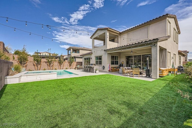 rear view of property featuring a fenced backyard, outdoor lounge area, stucco siding, and a balcony