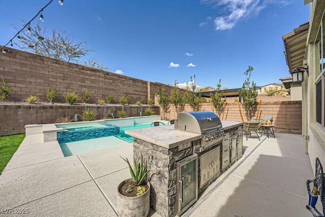 view of pool featuring exterior kitchen, grilling area, a fenced backyard, a fenced in pool, and a patio area