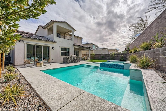 view of swimming pool featuring a fenced backyard, a patio, and a pool with connected hot tub