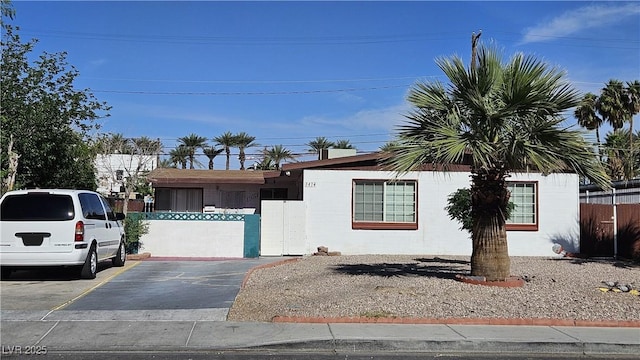single story home with fence and uncovered parking