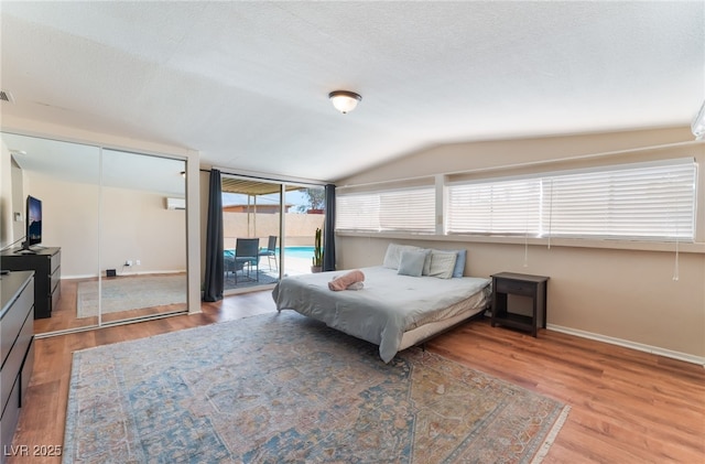 1615 Palora Ave, Las Vegas, NV 89169 - bedroom with access to exterior, wood finished floors, vaulted ceiling, and baseboards