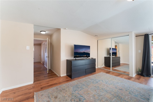 1615 Palora Ave, Las Vegas, NV 89169 - bedroom with wood finished floors, baseboards, lofted ceiling, and a closet