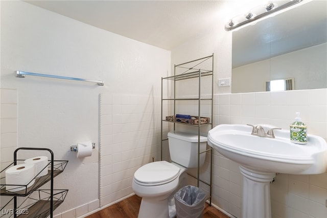1615 Palora Ave, Las Vegas, NV 89169 - half bathroom with wood finished floors, toilet, and tile walls