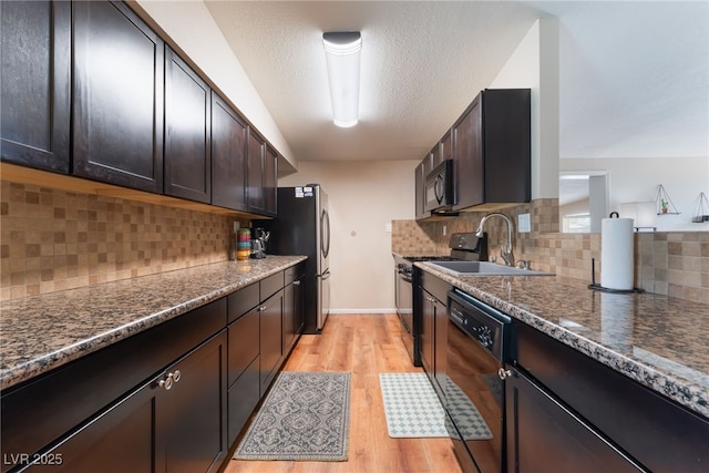 1615 Palora Ave, Las Vegas, NV 89169 - kitchen featuring black appliances, light wood finished floors, a sink, dark brown cabinets, and decorative backsplash