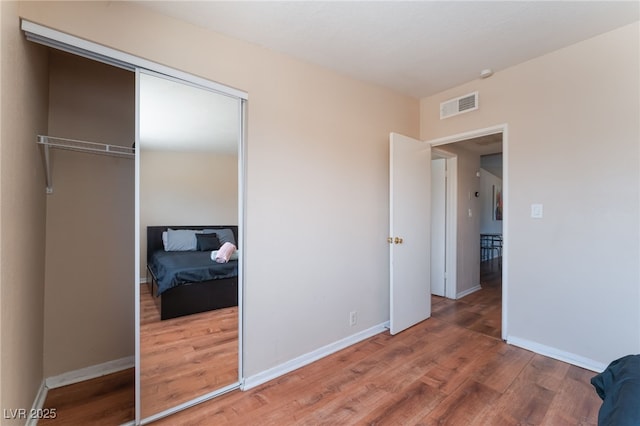 1615 Palora Ave, Las Vegas, NV 89169 - unfurnished bedroom featuring wood finished floors, a closet, and baseboards