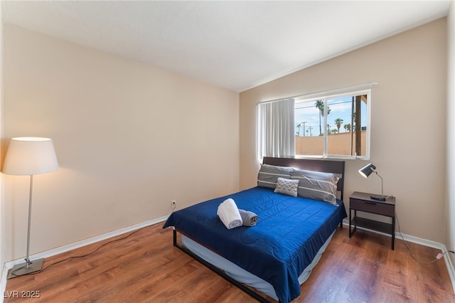 1615 Palora Ave, Las Vegas, NV 89169 - bedroom featuring wood finished floors, lofted ceiling, and baseboards